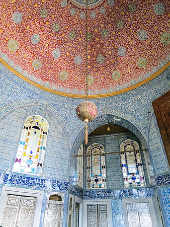 Ornate blue tiled interior with red patterned dome ceiling