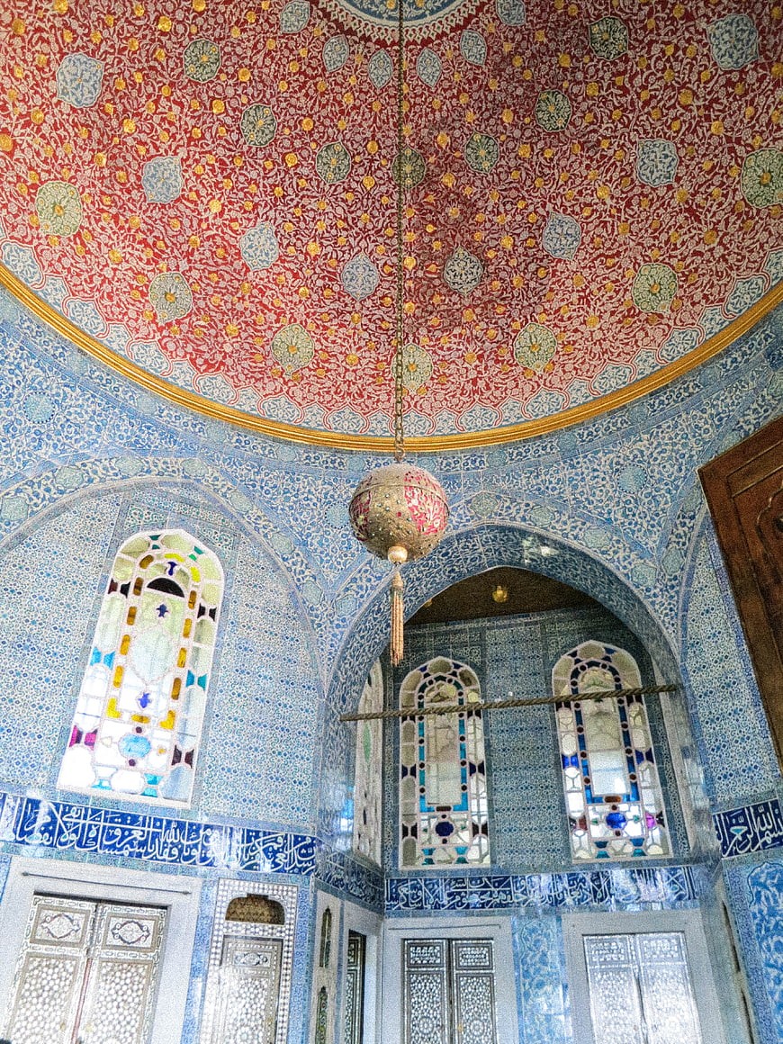 Ornate blue tiled interior with red patterned dome ceiling