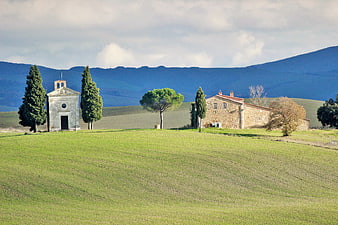 Tuscan landscape with chapel, farmhouse, and cypress trees