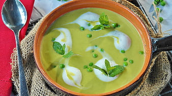 Creamy Green Pea Soup with Mint Garnish in Ceramic Bowl