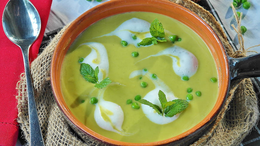 Creamy Green Pea Soup with Mint Garnish in Ceramic Bowl