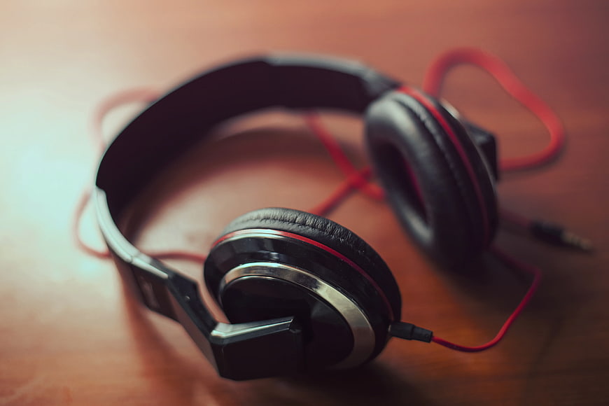 Black and Red Wired Headphones on Wooden Surface