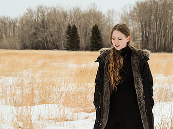 Woman in Winter Parka Standing in Snowy Field