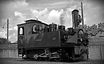 Vintage Black and White Steam Locomotive on Tracks