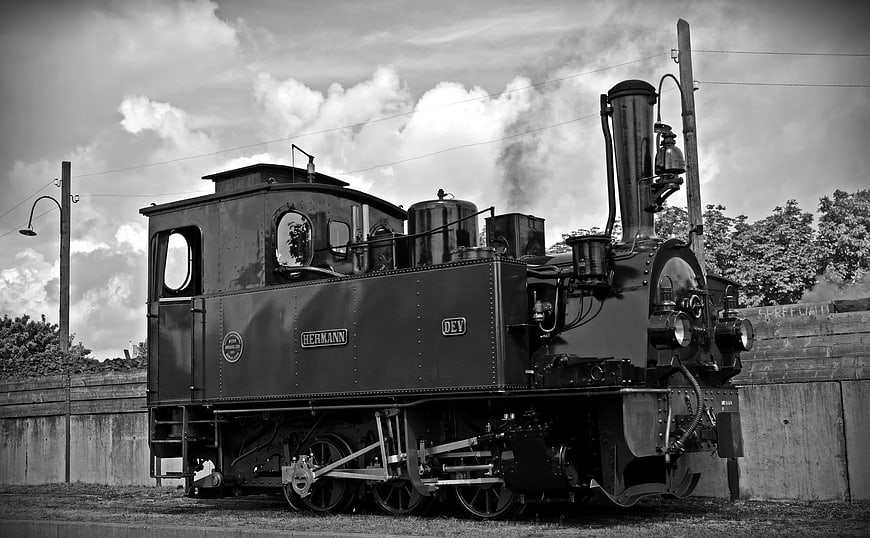 Vintage Black and White Steam Locomotive on Tracks
