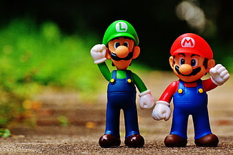 Mario and Luigi figurines standing on a path
