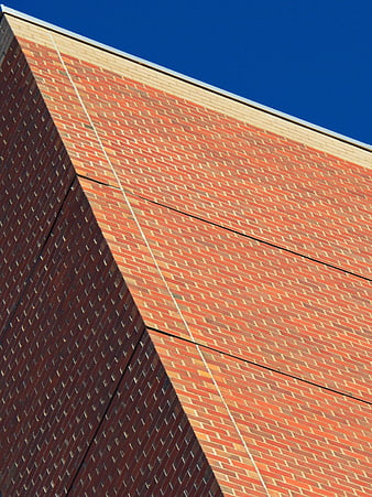 Abstract Red Brick Building Facade Against Blue Sky