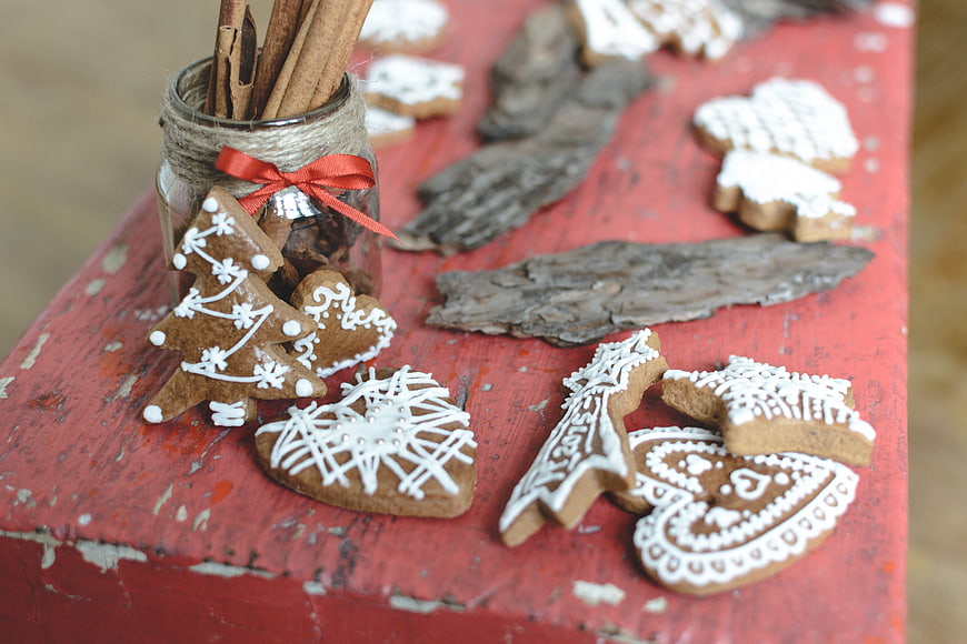 Traditional Christmas gingerbread cookies on rustic red wood