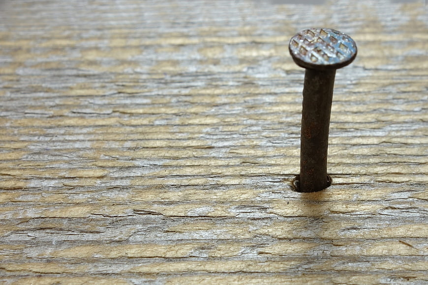 Rusty Nail in Weathered Wood with Copyspace