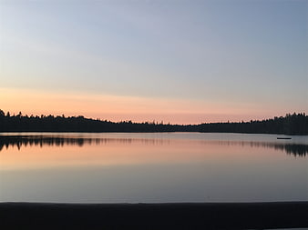 Serene Lake Sunset with Forest Silhouette and Reflection