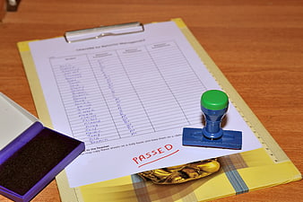 Passed rubber stamp on student behavior checklist clipboard