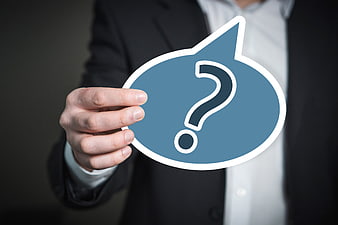 Businessman Holding Blue Question Mark Icon