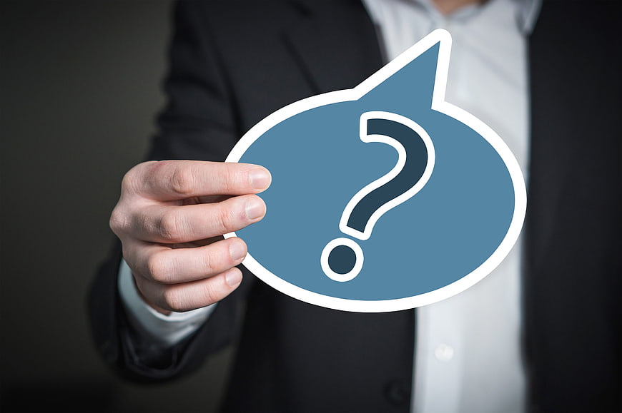 Businessman Holding Blue Question Mark Icon