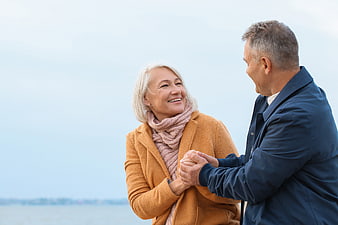 Happy Senior Couple Holding Hands Outdoors