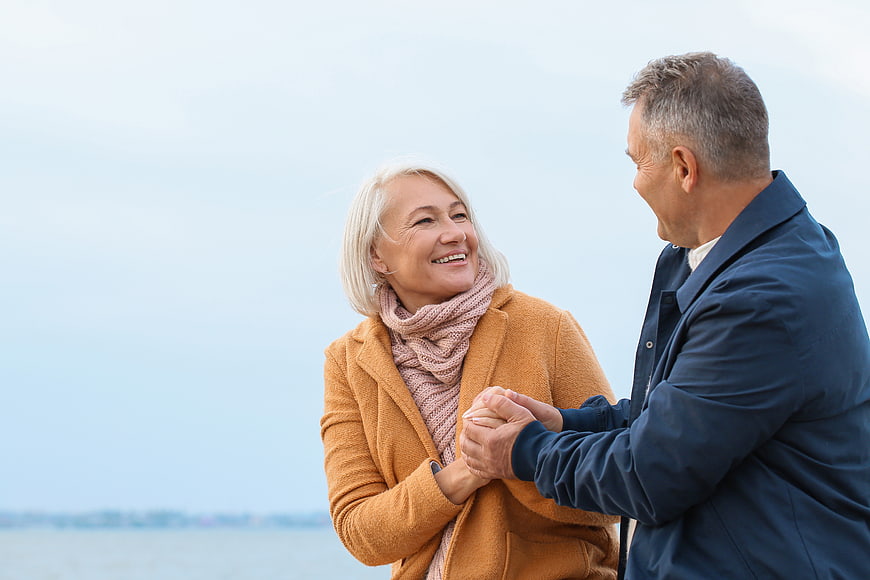 Happy Senior Couple Holding Hands Outdoors