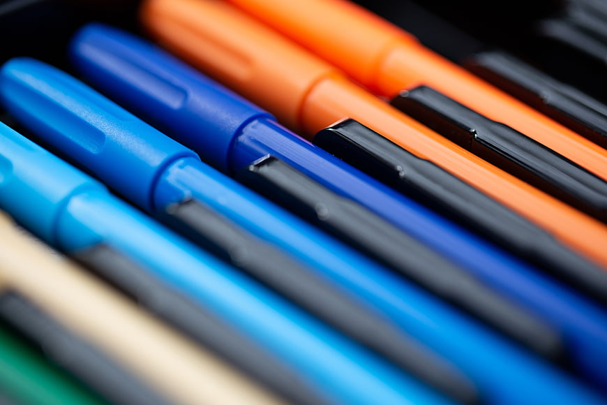 Close-up of colorful markers in a row