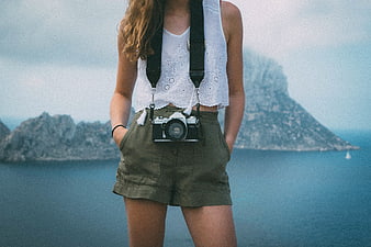Woman with Vintage Camera Against Coastal Mountain Backdrop