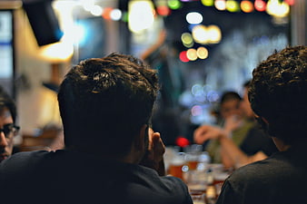 Back view of men watching live music in a bar