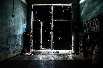 Dark abandoned pharmacy interior with city lights at night