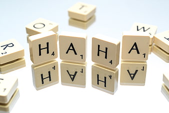 Scrabble tiles spelling Haha on white background