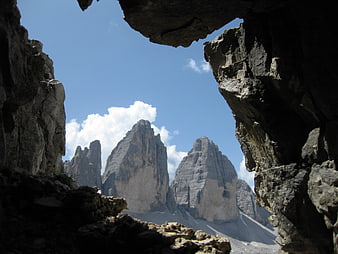 Dramatic Dolomites Peaks Framed by Dark Cave Opening