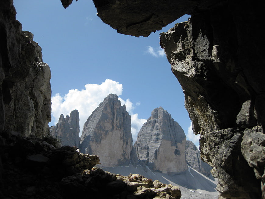 Dramatic Dolomites Peaks Framed by Dark Cave Opening