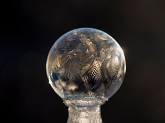 Frosted glass ornament with intricate ice crystals