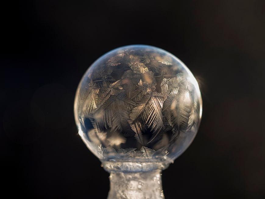 Frosted glass ornament with intricate ice crystals