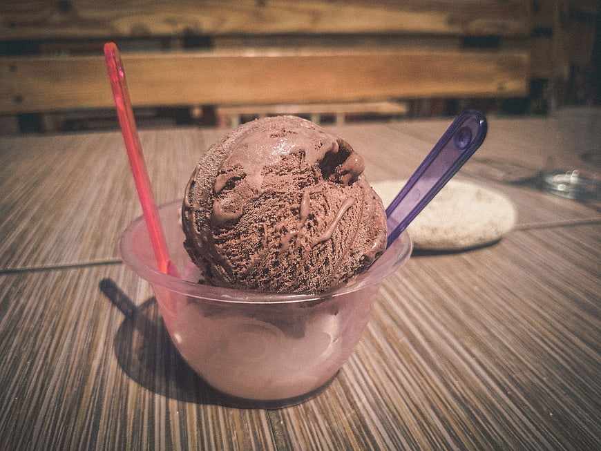 Chocolate Ice Cream Scoop in Plastic Cup with Spoon