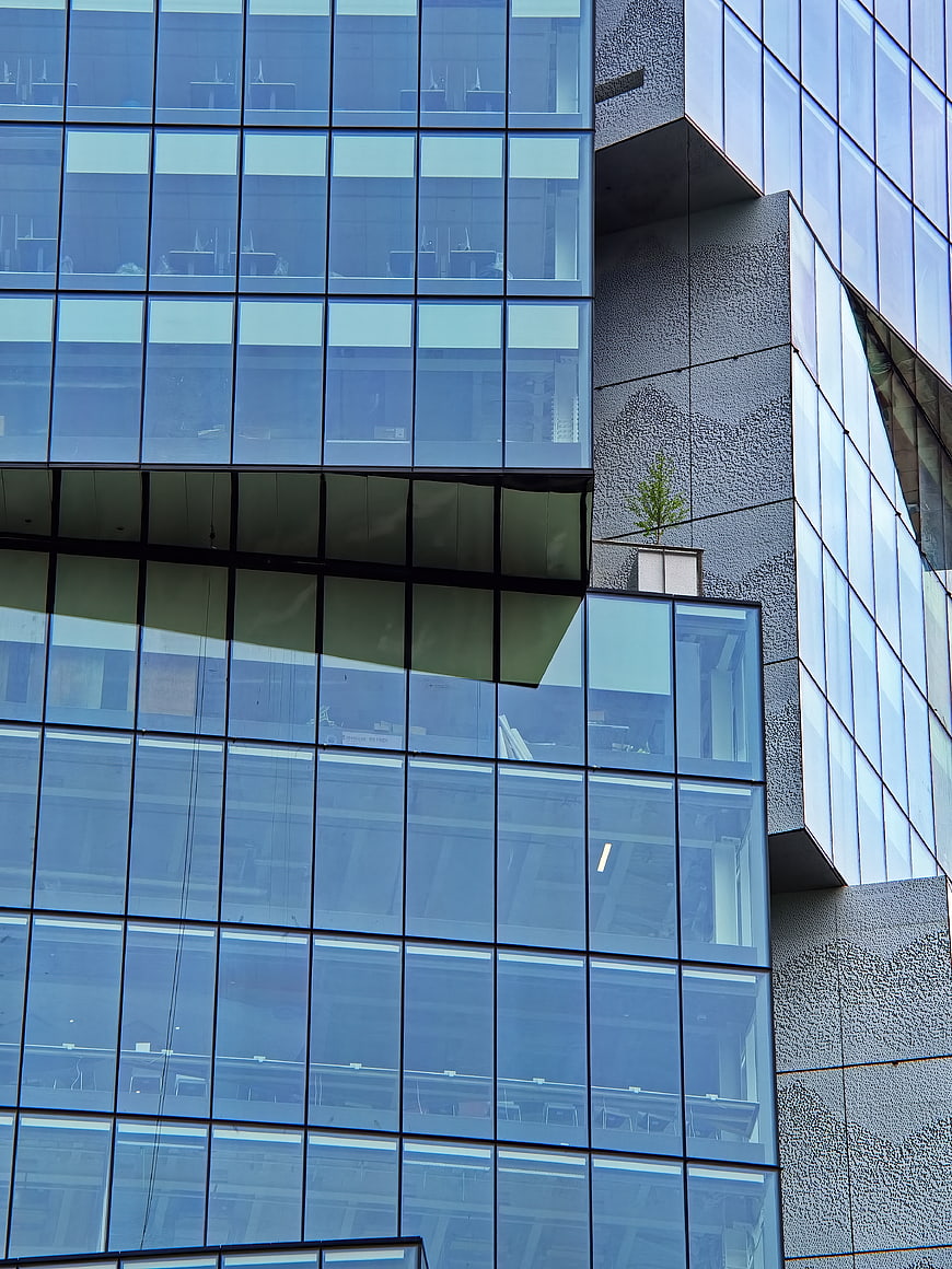 Modern Glass Office Building Facade with Geometric Design