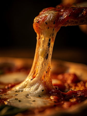 Close-up of melted cheese pull on pizza slice