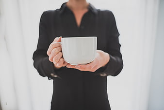 Woman in Black Blazer Holding White Coffee Cup