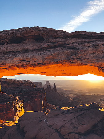 Sunset View Through Natural Rock Arch in Canyon Landscape