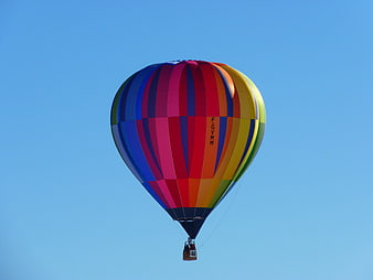 Colorful Hot Air Balloon Flying Against Clear Blue Sky
