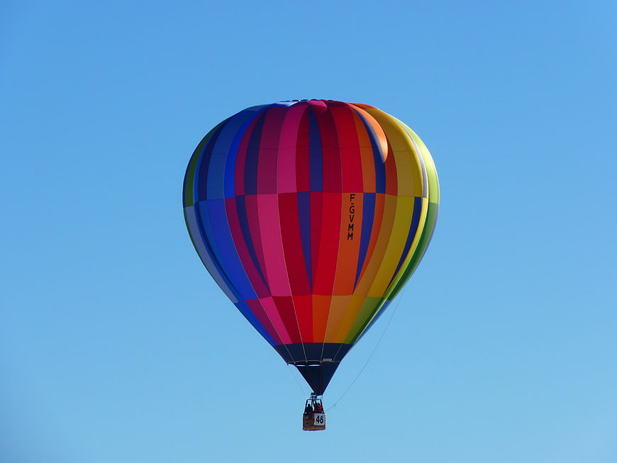 Colorful Hot Air Balloon Flying Against Clear Blue Sky