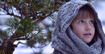 Young Girl in Grey Knitted Hood Looking Up in Snow