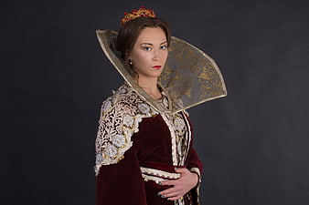 Portrait of a woman in a historical royal costume with a crown