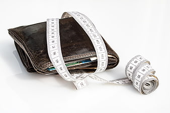 Leather Wallet Wrapped with Measuring Tape on White Background