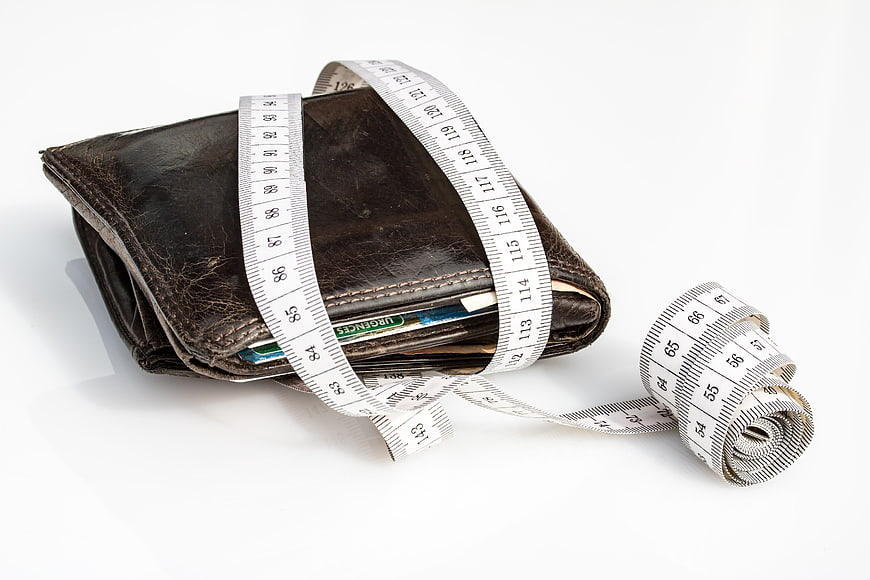 Leather Wallet Wrapped with Measuring Tape on White Background