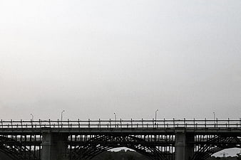 Silhouette of steel bridge against overcast sky