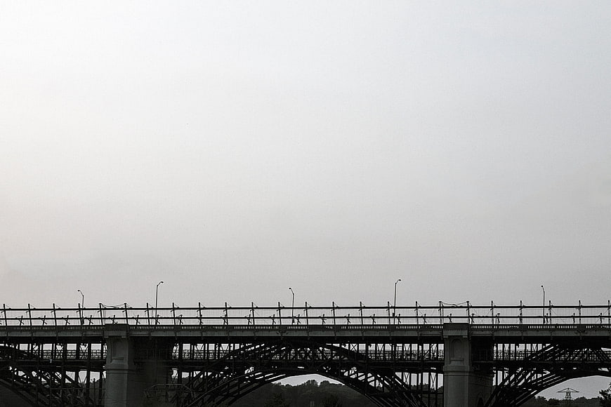 Silhouette of steel bridge against overcast sky