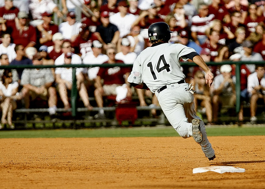Baseball Player Number 14 Running on Dirt Field