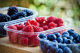 Fresh Raspberries, Blueberries, and Blackberries in Plastic Containers