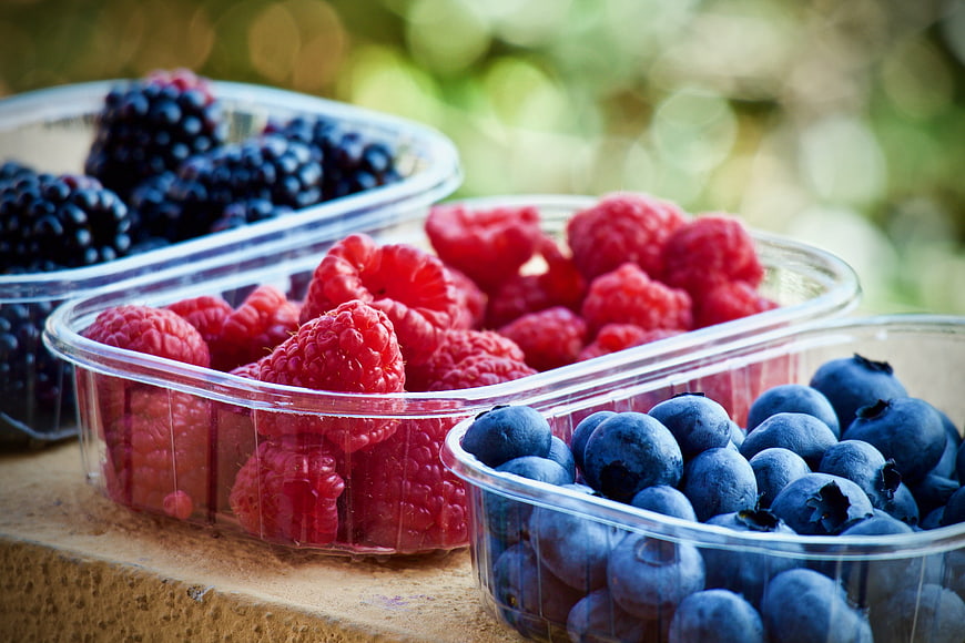 Fresh Raspberries, Blueberries, and Blackberries in Plastic Containers