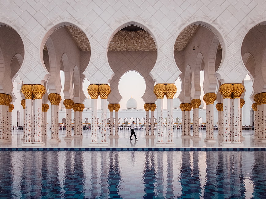 Grand Mosque Interior with Arches and Reflections