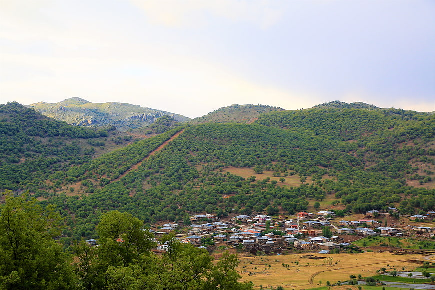 Rural village nestled in green mountain valley landscape