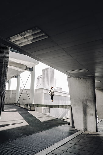 Man Floating in Brutalist Concrete Architecture
