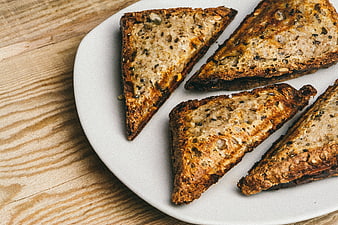 Toasted multigrain bread triangles on a white plate