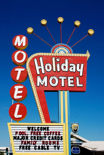 Vintage Holiday Motel Sign Against Clear Blue Sky