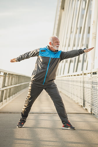 Active Senior Man Stretching on Bridge